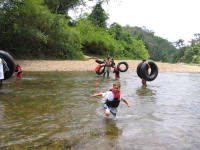Crossing the Sibun River at the start of the Cave Tubing Excursion